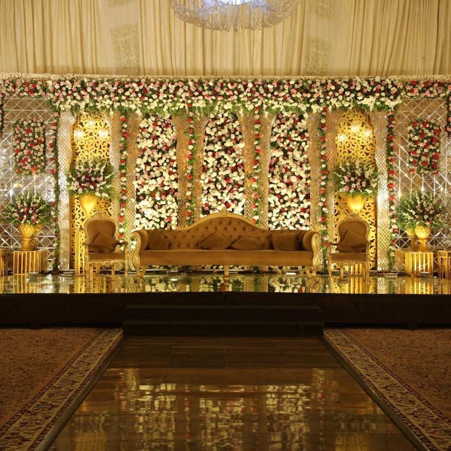 A bridal stage dressed in white florals by the Gourmet décor team
